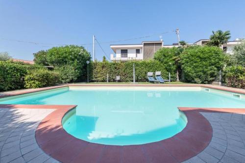 a large swimming pool with blue water at Trento33 in Lazise