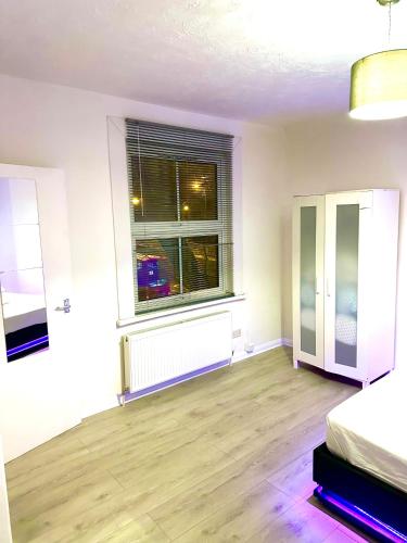 an empty room with a window and a bed at Studio flat in central London in London