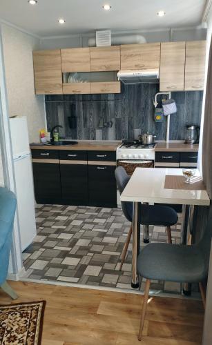 a kitchen with a table and chairs in a room at Stropi Apartment Daugavpils in Daugavpils