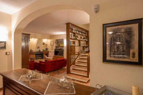 a living room with an archway and a staircase in a house at Cascina Albarella in Canelli