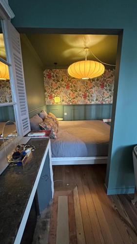 a bedroom with a large bed with a yellow ceiling at La Maison Mulatô, demeure privée d'hôtes, piscine & spa Libourne, Saint-Emilion in Libourne