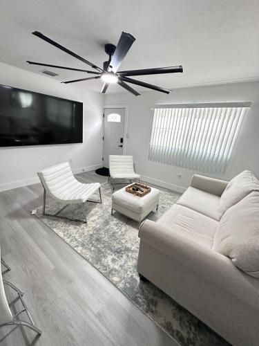 a living room with a couch and a ceiling fan at Cozy Retreat Near Downtown Fort Myers in Fort Myers