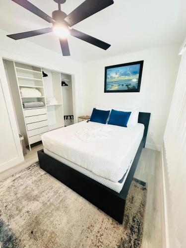 a bedroom with a bed with a ceiling fan at Cozy Retreat Near Downtown Fort Myers in Fort Myers
