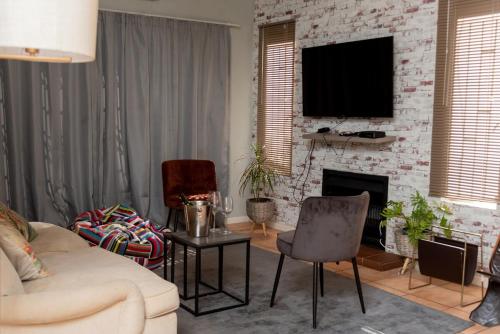 a living room with a couch and a fireplace at Chic and Secure Phakalane Stay in Gaborone