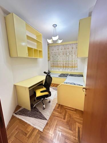 a room with a desk and a bed and a chair at Milenijum in Podgorica