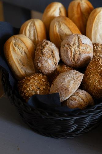 a basket filled with different types of bread at B&B Maas en Heuvel Maastricht in Maastricht