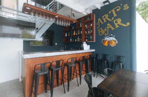 a bar with a bunch of bar stools in a restaurant at Grospe Resort Boracay in Boracay