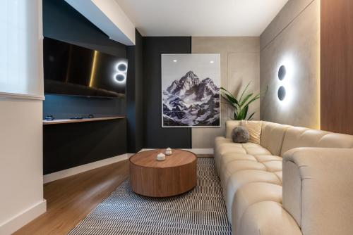 a living room with a couch and a table at Exclusive Mariano Santos 179 Residences by Geko in Lima