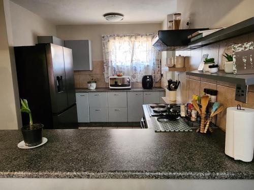 a kitchen with a counter top and a stove top oven at Pearl palace in Polokwane