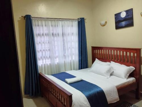 En eller flere senge i et værelse på Tawa Luxe