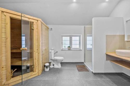 a bathroom with a toilet and a sink at 6727-Hasle-Udmarksvej-10 in Hasle