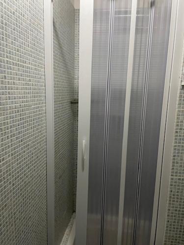 a shower stall with a glass door in a bathroom at Appartamento Santi in Fiumalbo