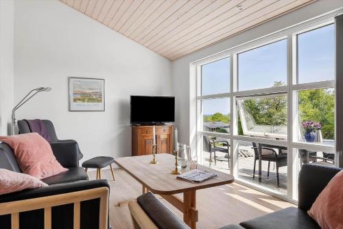 a living room with a couch and a table and a television at 6838-Allinge-Stakkebakken-9 in Allinge