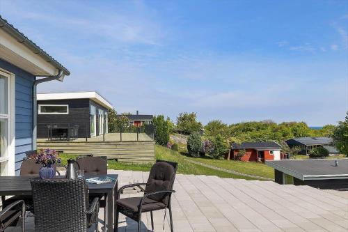 a patio with a table and chairs on a patio at 6838-Allinge-Stakkebakken-9 in Allinge