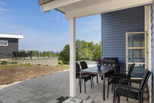 a patio with a table and chairs on a house at 6838-Allinge-Stakkebakken-9 in Allinge
