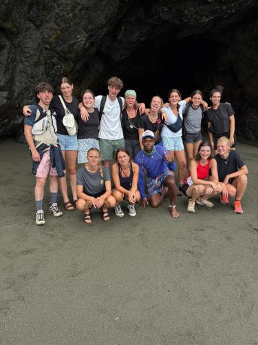 a group of people posing for a picture in a cave at Hostal La Esmeralda in El Valle