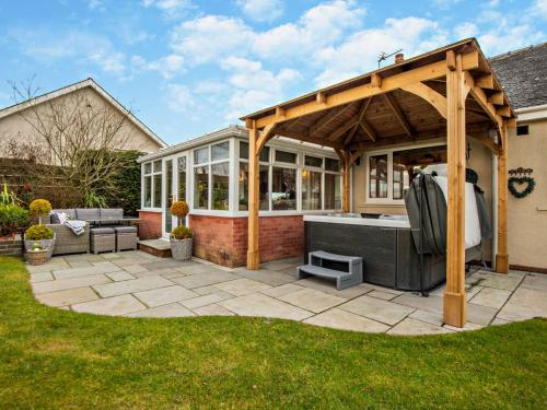 a pergola with a tub on a patio at 3 Bed in Cockermouth 82438 in Dearham