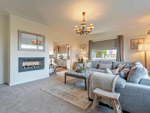 a living room with a couch and a fireplace at 3 Bed in Cockermouth 82438 in Dearham