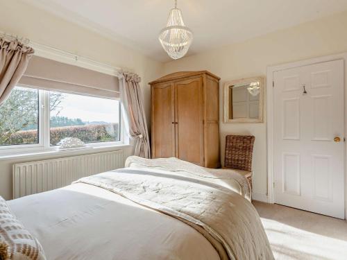 a bedroom with a large bed and a window at 3 Bed in Cockermouth 82438 in Dearham
