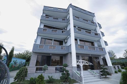 a tall apartment building with a lot of windows at Hotel Harmony Premium in Kutaisi