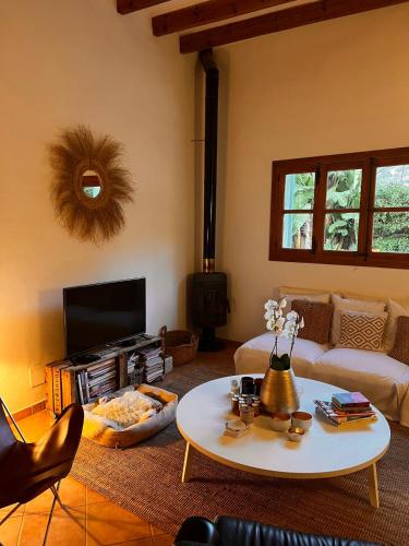a living room with a couch and a table at Luxurious finca with pool, Soller - Mallorca in Sóller