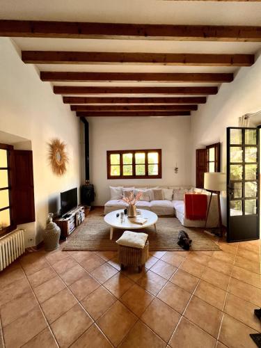 a living room with a couch and a table at Luxurious finca with pool, Soller - Mallorca in Sóller