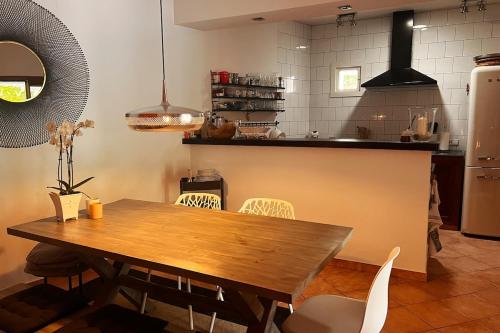 a kitchen with a wooden table and chairs at Luxurious finca with pool, Soller - Mallorca in Sóller