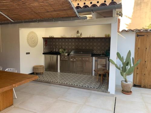 an outdoor kitchen with a counter and a table at Luxurious finca with pool, Soller - Mallorca in Sóller