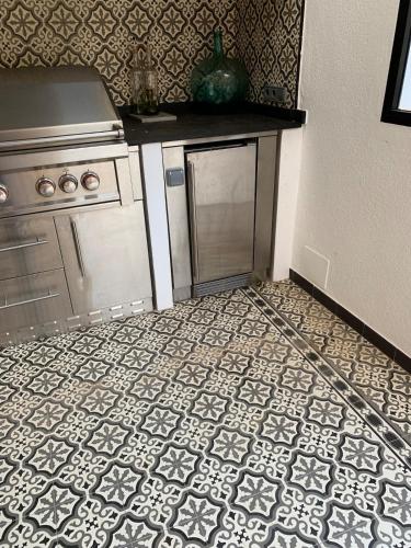 a kitchen with a counter and a tile floor at Luxurious finca with pool, Soller - Mallorca in Sóller
