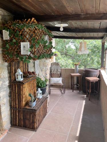 an outdoor patio with a chair and a table and a chair at A casa di Giovanni apartment in Albano di Lucania
