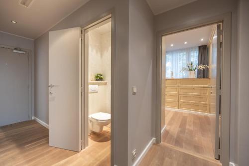 a bathroom with a toilet and a window at Leonardo Hotel Antwerp The Plaza in Antwerp