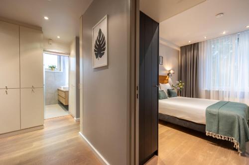 a hotel room with a bed and a bathroom at Leonardo Hotel Antwerp The Plaza in Antwerp