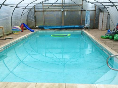 a swimming pool in a dome tent with a pool noodle in it at Vincent Studio in Snape