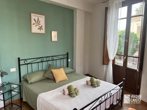 a bedroom with a bed with two teddy bears on it at Verdincanto Relax e comfort a due passi dal centro in Lucca
