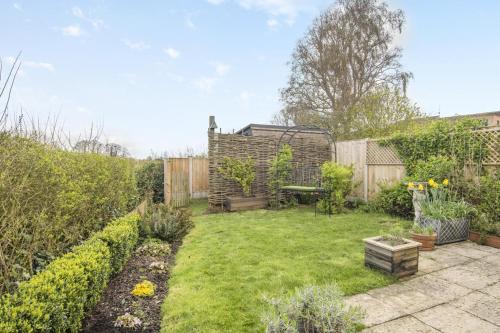 a small backyard with a garden with a fence at Honeysuckle in Halesworth
