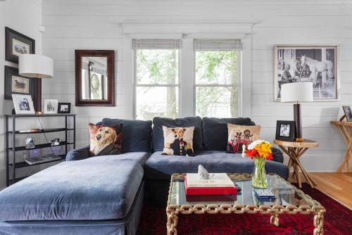 a living room with a blue couch and a table at Best in Show in Atlanta