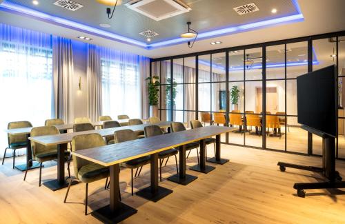 a conference room with a long table and chairs at Leonardo Hotel Hamburg Altona in Hamburg