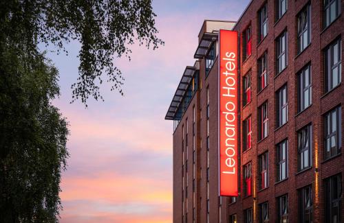 a red sign on the side of a building at Leonardo Hotel Hamburg Altona in Hamburg