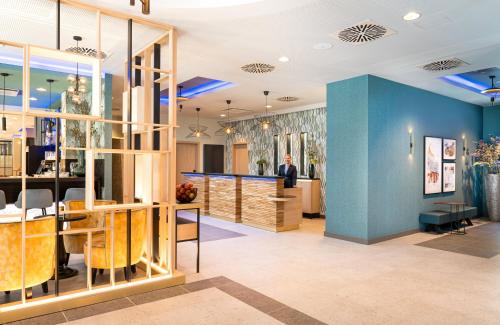 a store with blue walls and wooden furniture at Leonardo Hotel Hamburg Altona in Hamburg