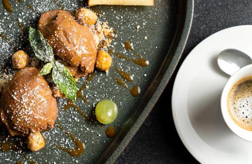 a plate of food on a table with a cup of coffee at Leonardo Hotel Hamburg Altona in Hamburg