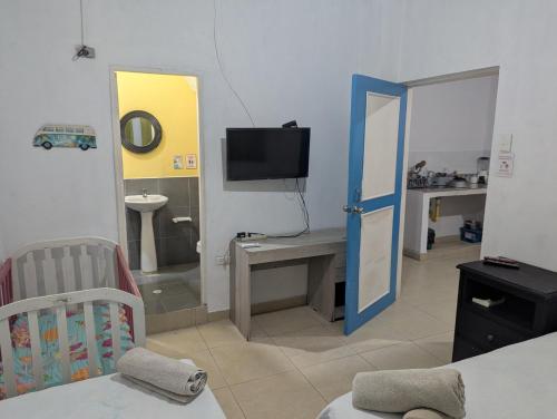 a room with a bedroom with a crib and a television at Casa de 2 pisos cerca a la playa in San Andrés