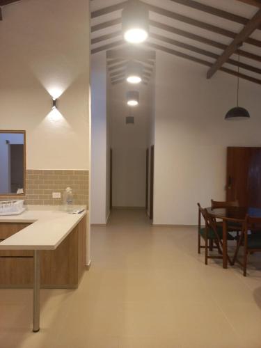 a large room with a counter and a dining room at Casa Nueva en Zapatoca in Zapatoca