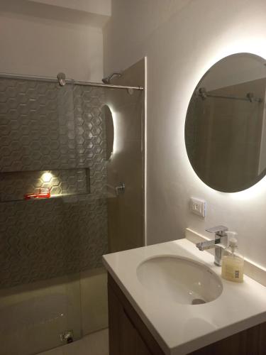 a bathroom with a sink and a mirror and a shower at Casa Nueva en Zapatoca in Zapatoca