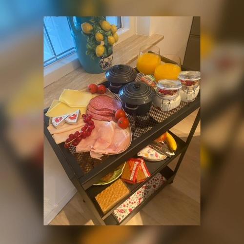 a shelf with meat and cheese and other food at Bed & Breakfast Betuws Genieten in Tiel