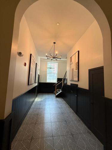 an empty hallway with a ceiling with a chandelier at Modern 1-Bedroom Apartment in Downtown Baltimore in Baltimore