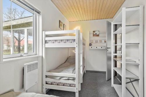 a room with white bunk beds and a window at OH333-Storvorde-Frydenstrand-56 in Storvorde