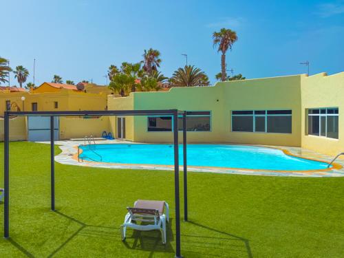 a swimming pool in the yard of a house at Blue Río Playa, Casa & Studio in Costa Calma