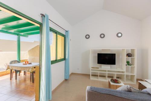 a living room with a couch and a table at Blue Río Playa, Casa & Studio in Costa Calma