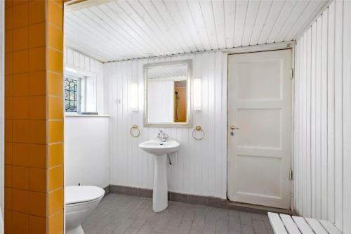 a white bathroom with a toilet and a sink at OH397-Storvorde-Kystvej-171 in Storvorde