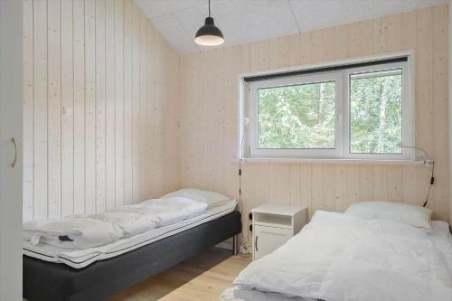 a room with two beds and a window at OH438-Hadsund-Sellegaarde-Vest-16-A in Hadsund